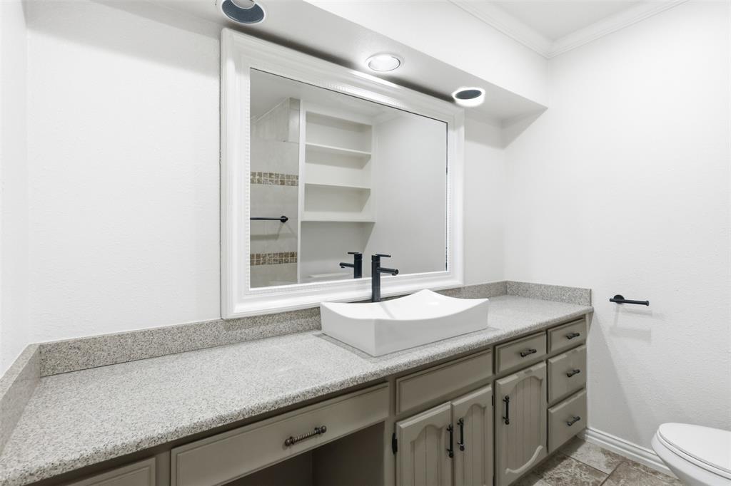 103 Paint Brush Road Lakeside, TX 76108 - Photo 16 of 24 a bathroom with a granite countertop sink a toilet and a mirror