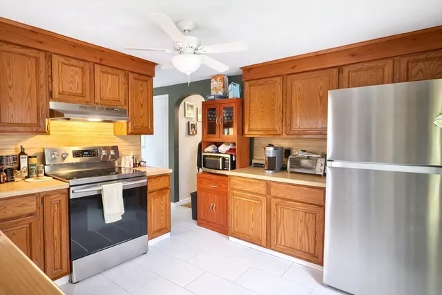 a kitchen with stainless steel appliances white cabinets and a refrigerator