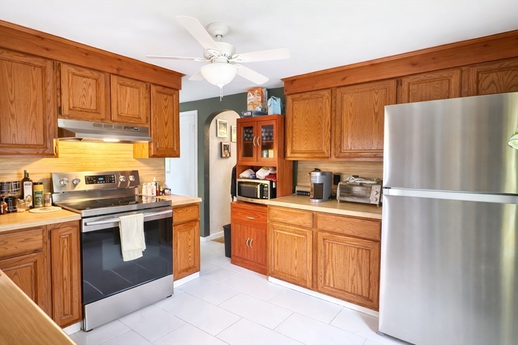 83 Gilman Street Springfield, MA 01118 - Photo 5 of 11 a kitchen with stainless steel appliances white cabinets and a refrigerator