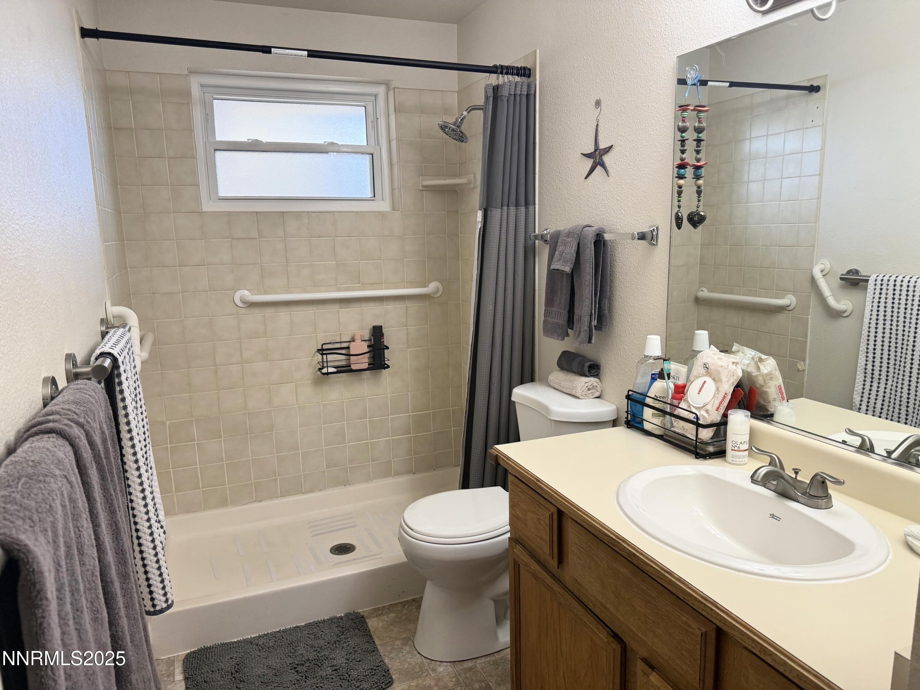 1348 Leonard Road Gardnerville, NV 89460 - Photo 11 of 13 a bathroom with a sink toilet tub and shower