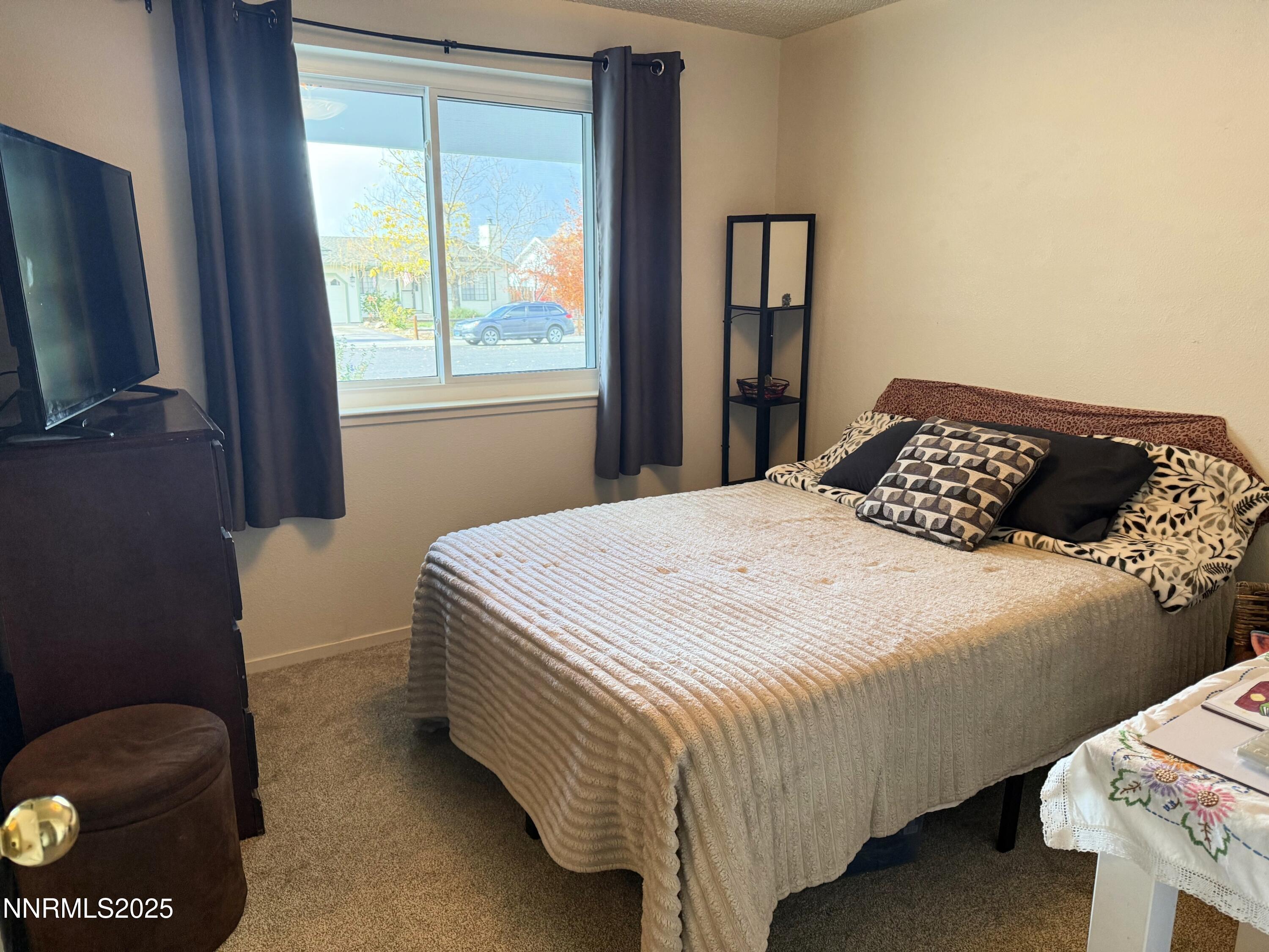 1348 Leonard Road Gardnerville, NV 89460 - Photo 10 of 13 a bedroom with a bed and a window