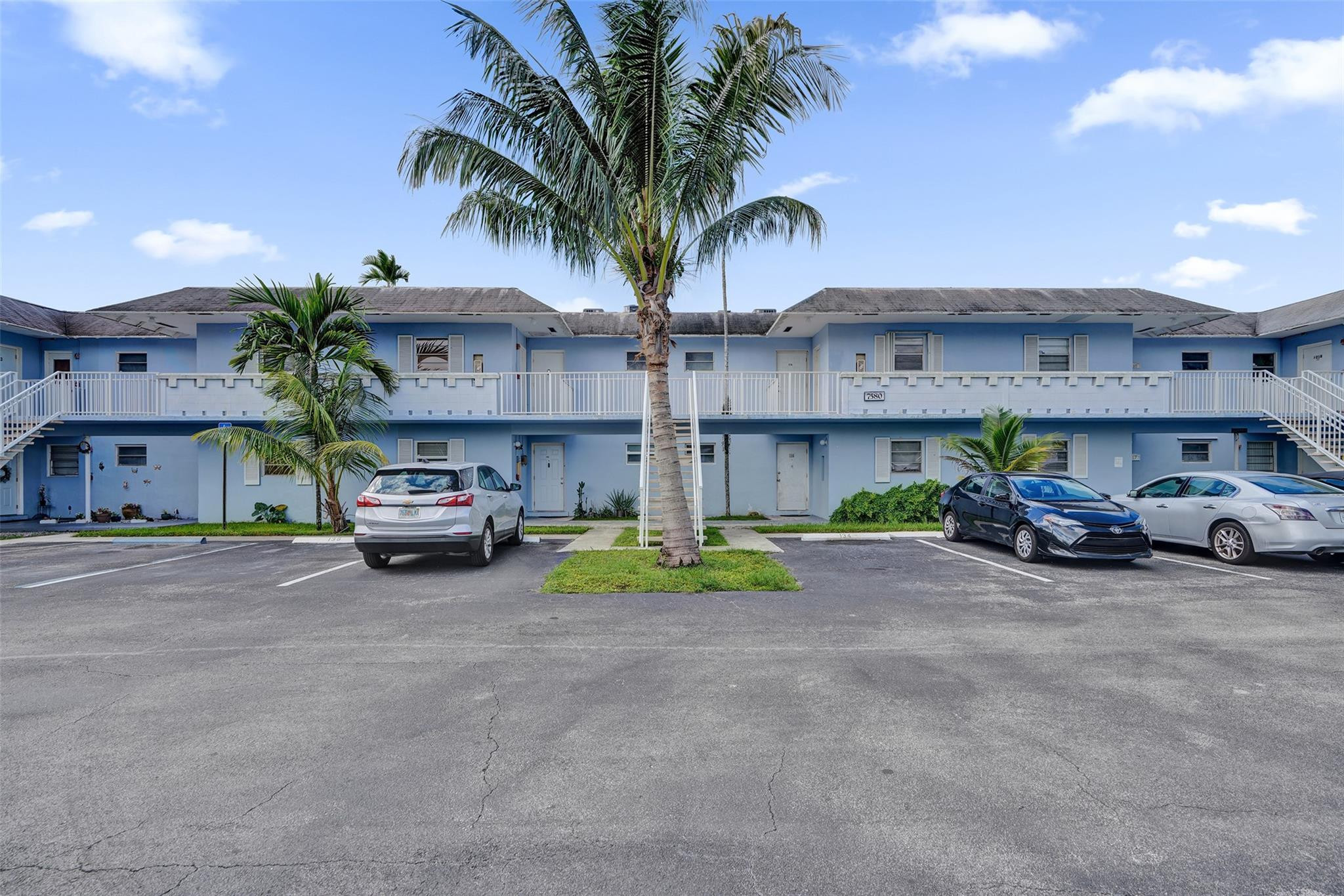 a view of a car is parked in front of a building