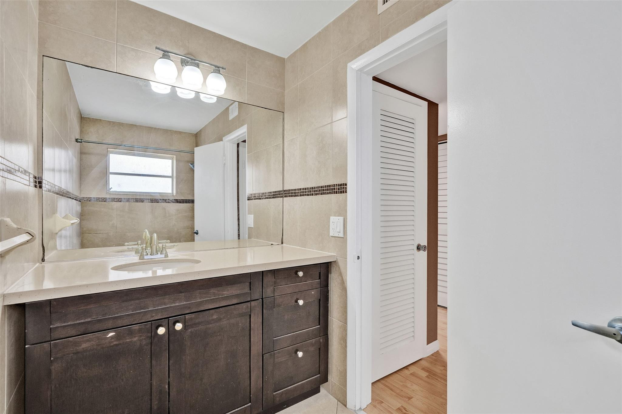 7580 Southwest 82nd Street Miami, FL 33143 - Photo 14 of 23 a bathroom with a double vanity sink and a mirror