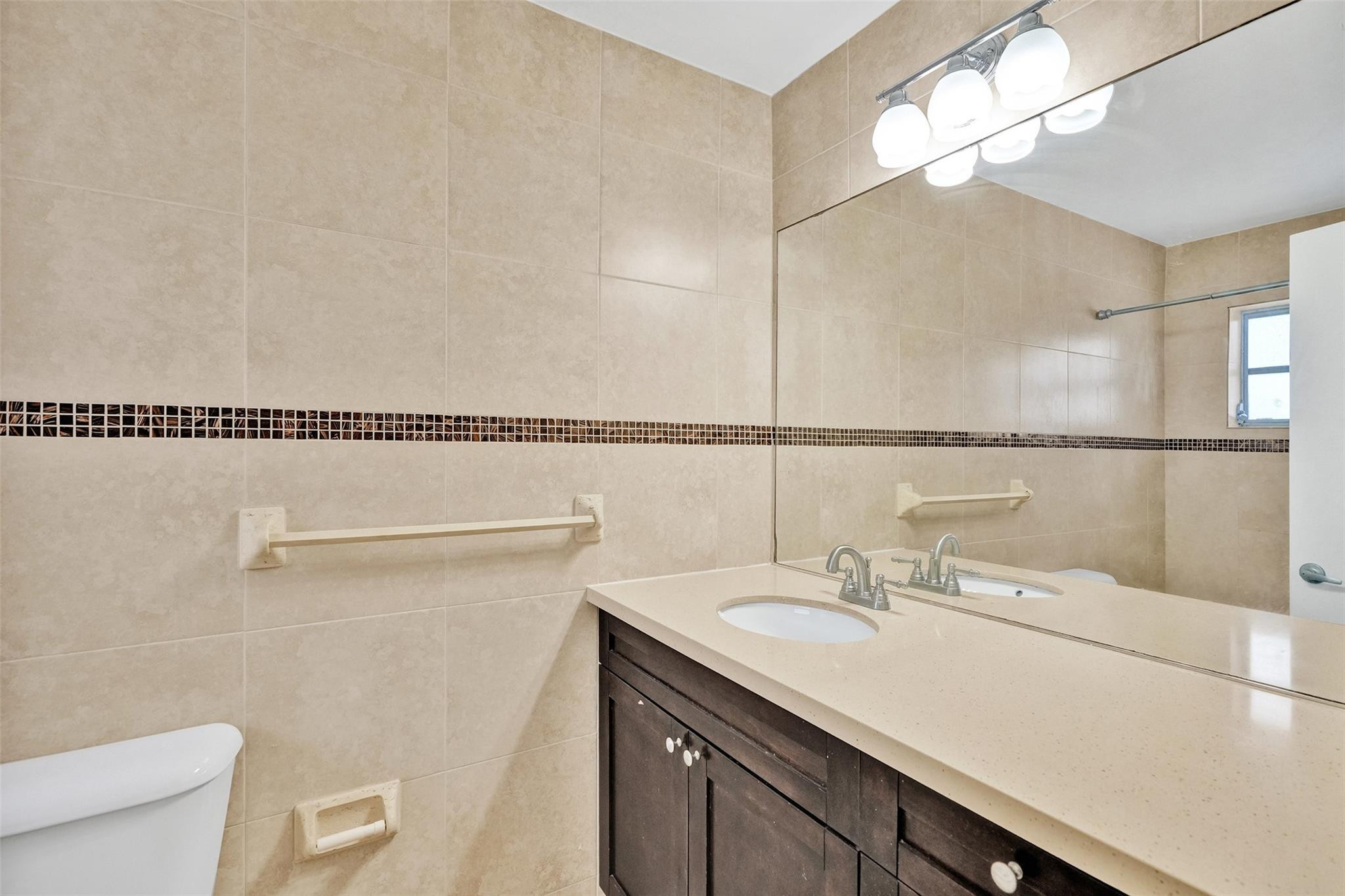 7580 Southwest 82nd Street Miami, FL 33143 - Photo 15 of 23 a bathroom with a sink a toilet and shower