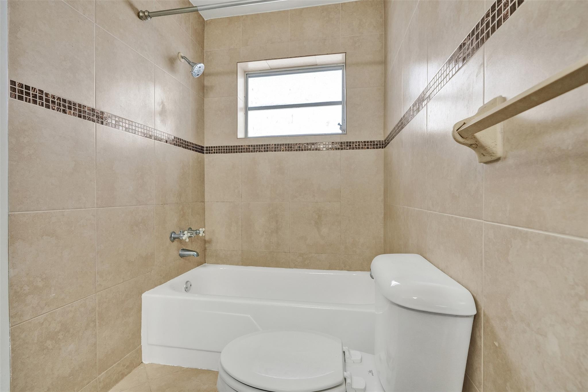 7580 Southwest 82nd Street Miami, FL 33143 - Photo 16 of 23 a bathroom with a toilet a sink and bathtub