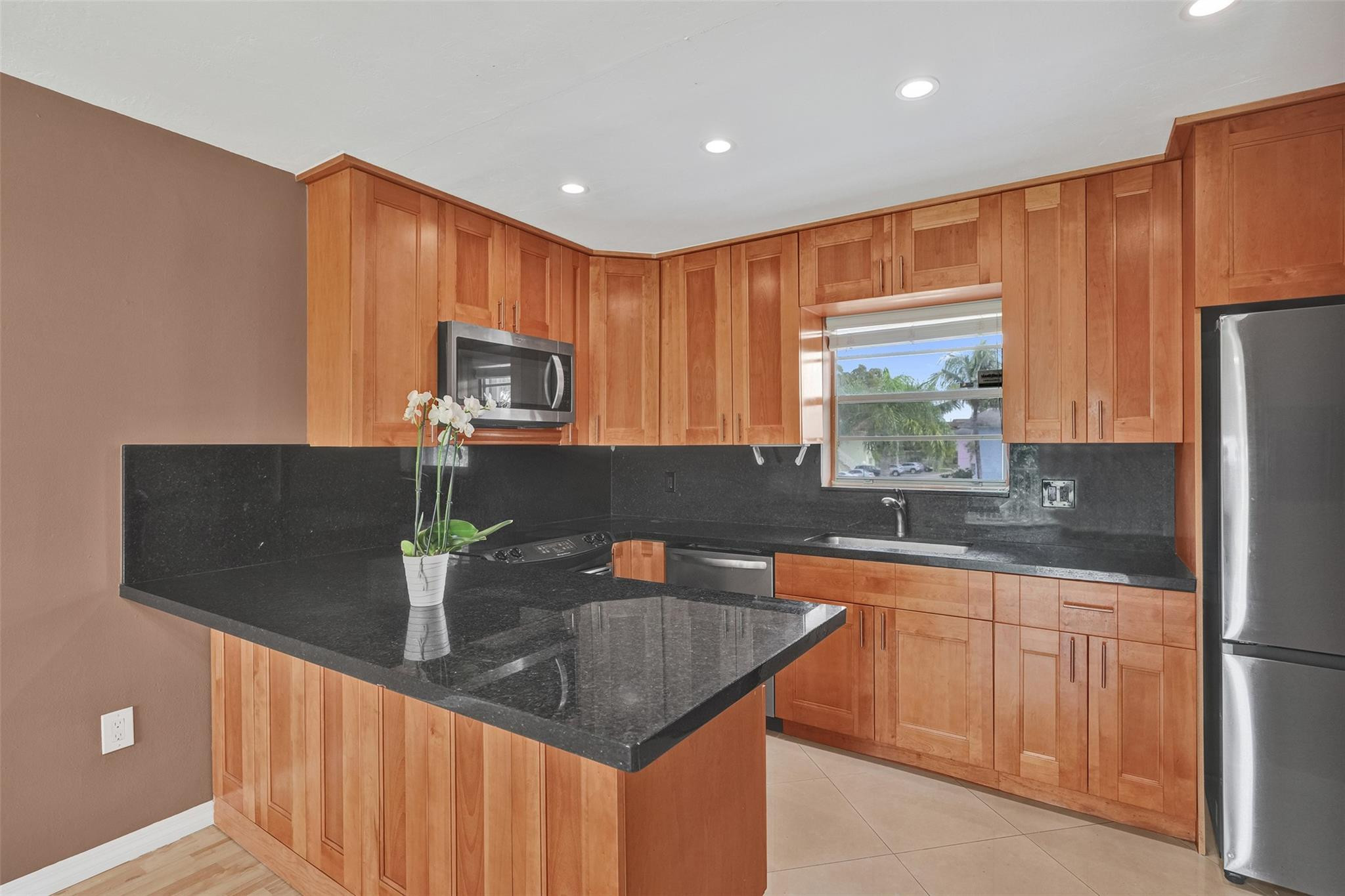7580 Southwest 82nd Street Miami, FL 33143 - Photo 4 of 23 a kitchen with stainless steel appliances granite countertop a sink a stove and a refrigerator