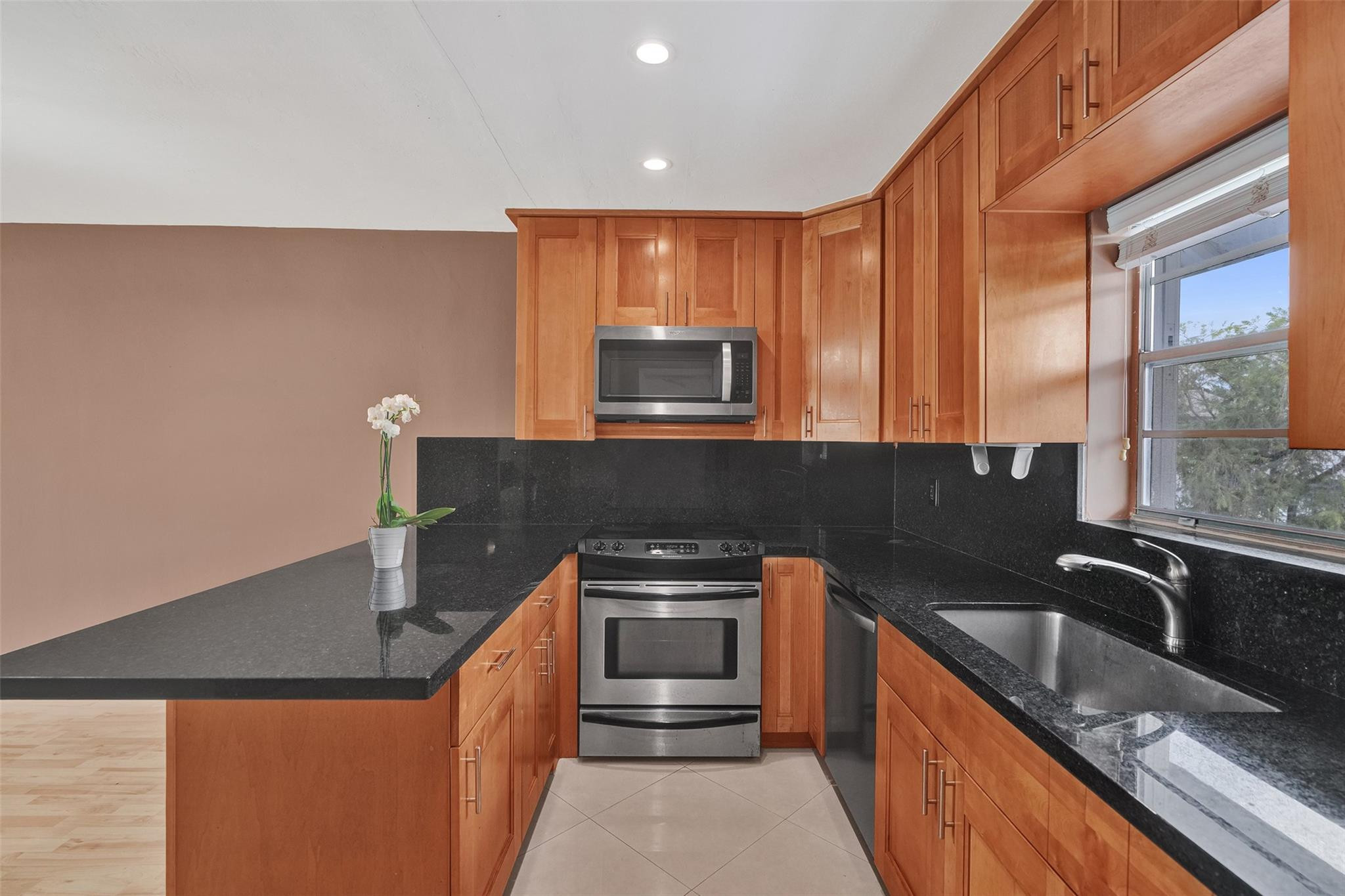 7580 Southwest 82nd Street Miami, FL 33143 - Photo 6 of 23 a kitchen with granite countertop a sink and steel appliances