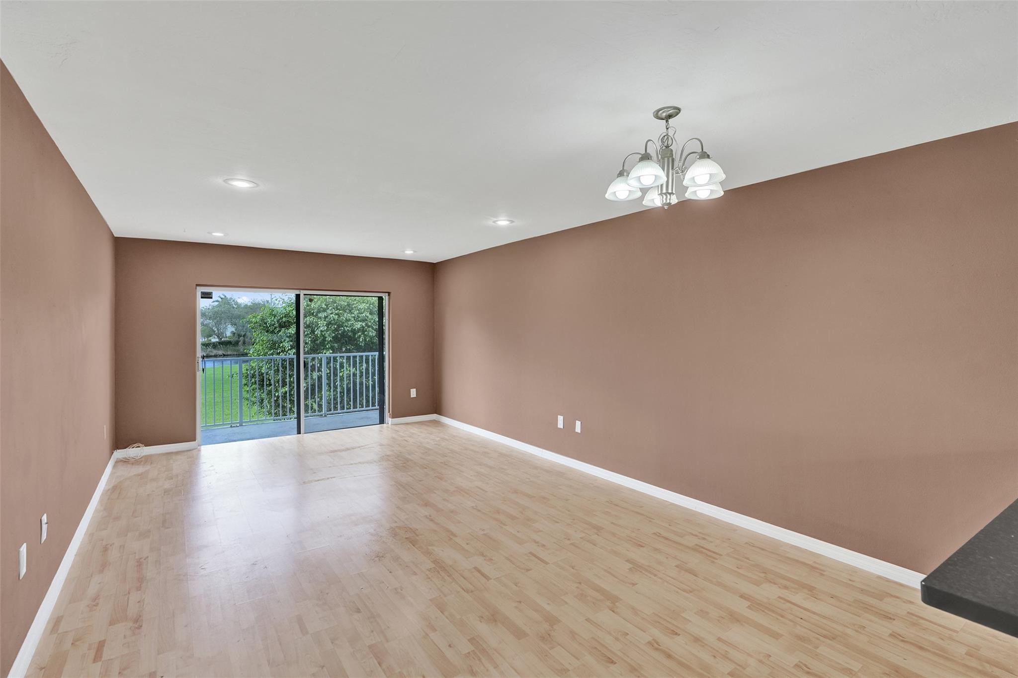 7580 Southwest 82nd Street Miami, FL 33143 - Photo 7 of 23 a view of an empty room with wooden floor and a window