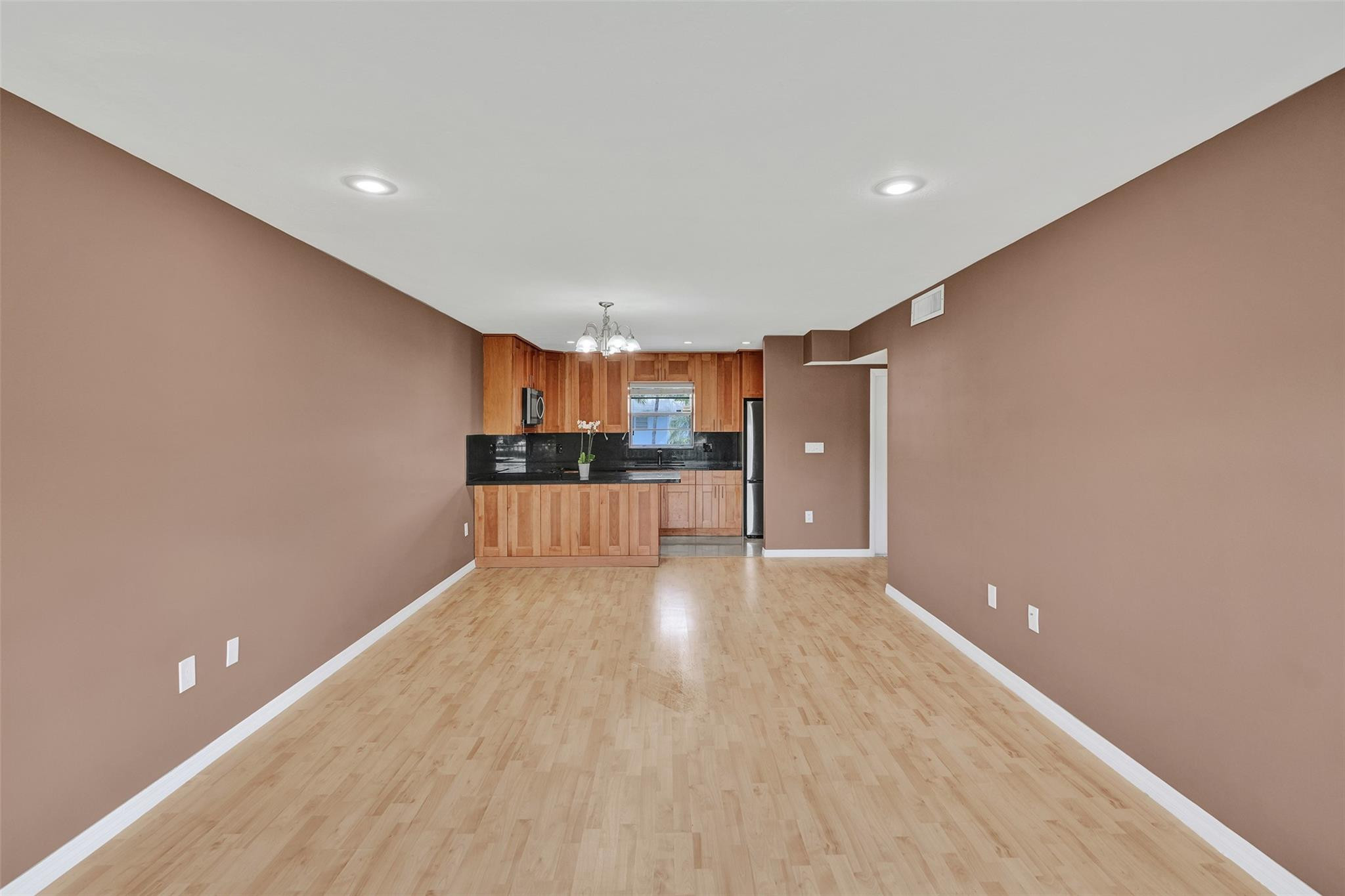 7580 Southwest 82nd Street Miami, FL 33143 - Photo 9 of 23 a view of a big room with wooden floor and windows
