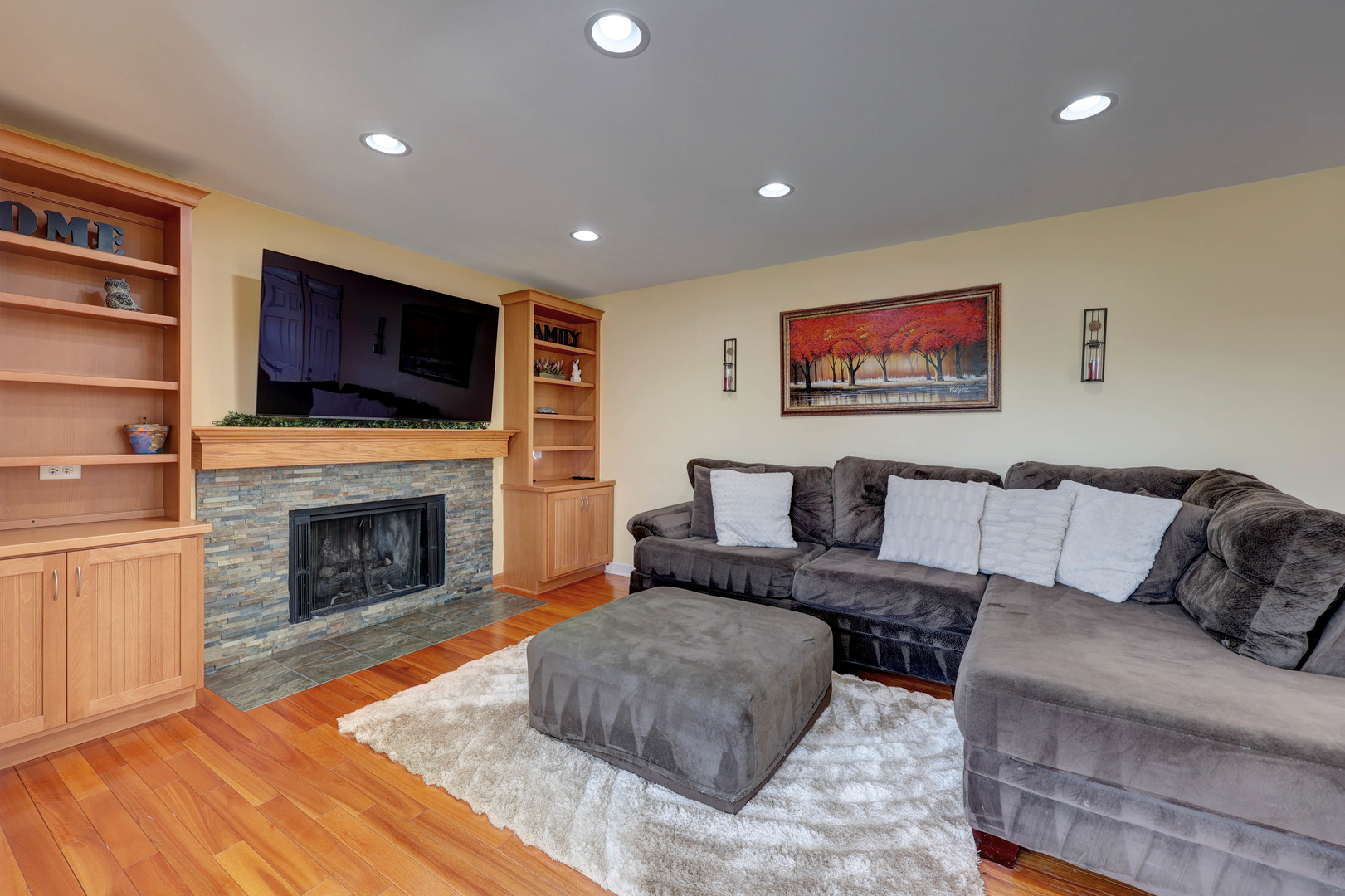 753 Holly Drive Bartlett, IL 60103 - Photo 16 of 43 a living room with furniture a fireplace and a flat screen tv