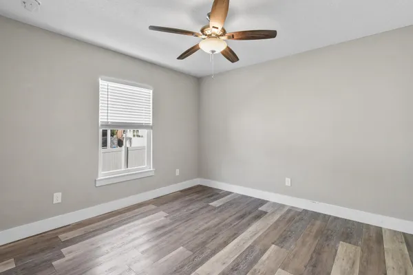 wooden floor in an empty room with a window