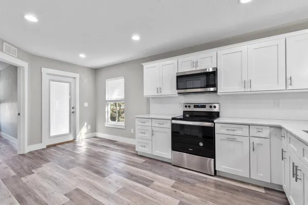 a kitchen with a stove and a microwave