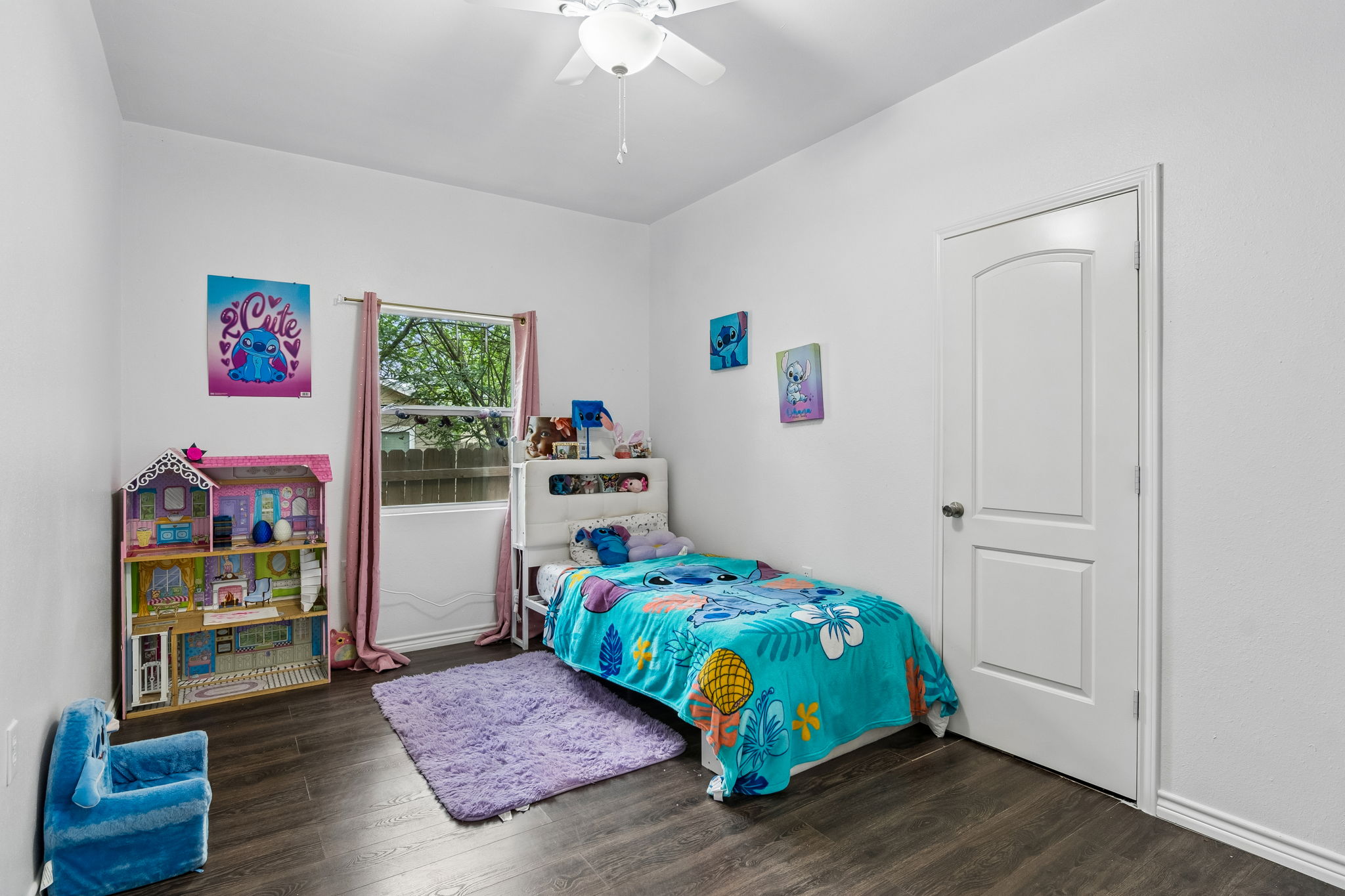 810 Lamar Street Luling, TX 78648 - Photo 15 of 21 a bedroom with a bed and wooden floor