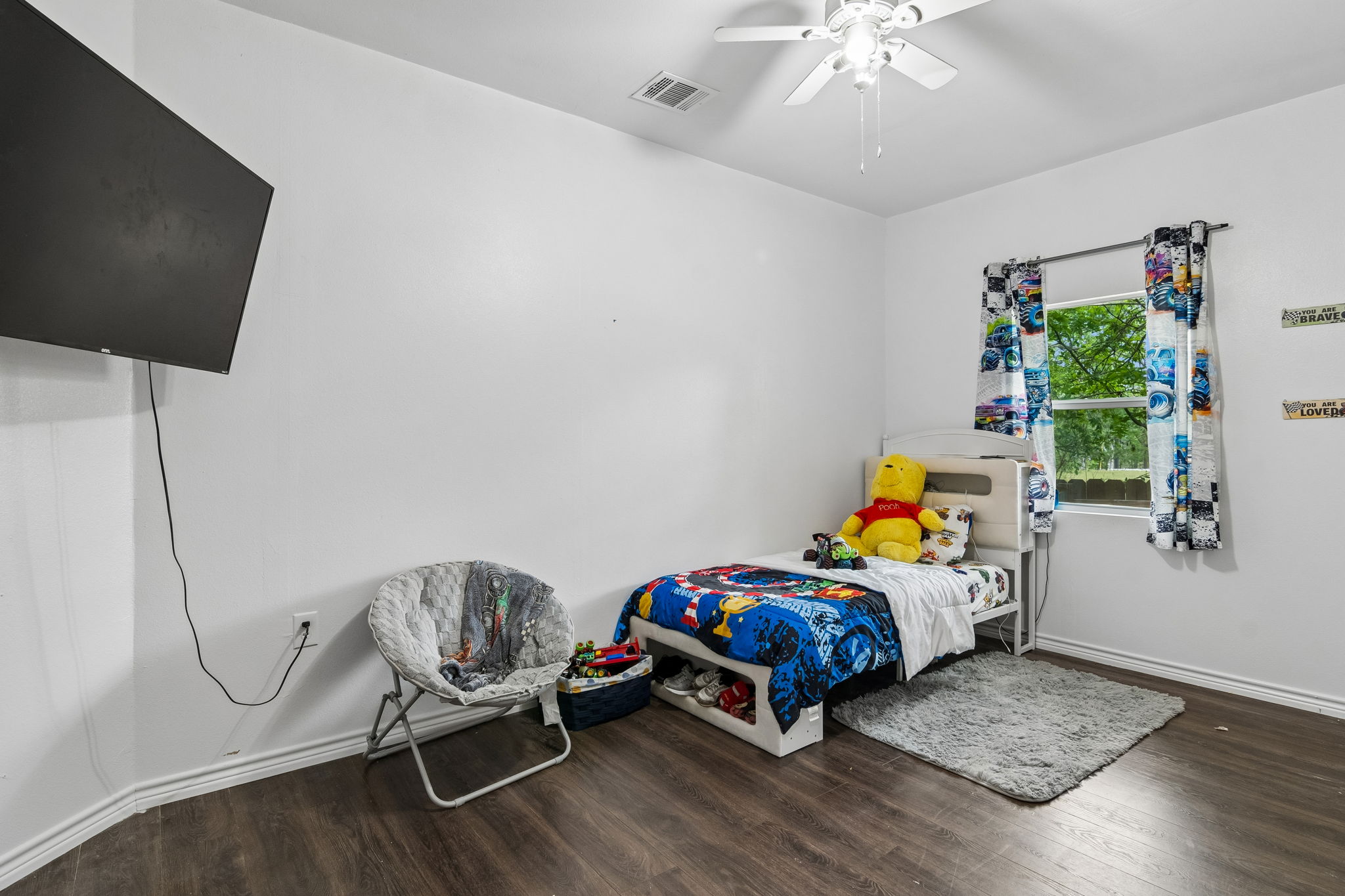 810 Lamar Street Luling, TX 78648 - Photo 16 of 21 a bedroom with furniture and a window