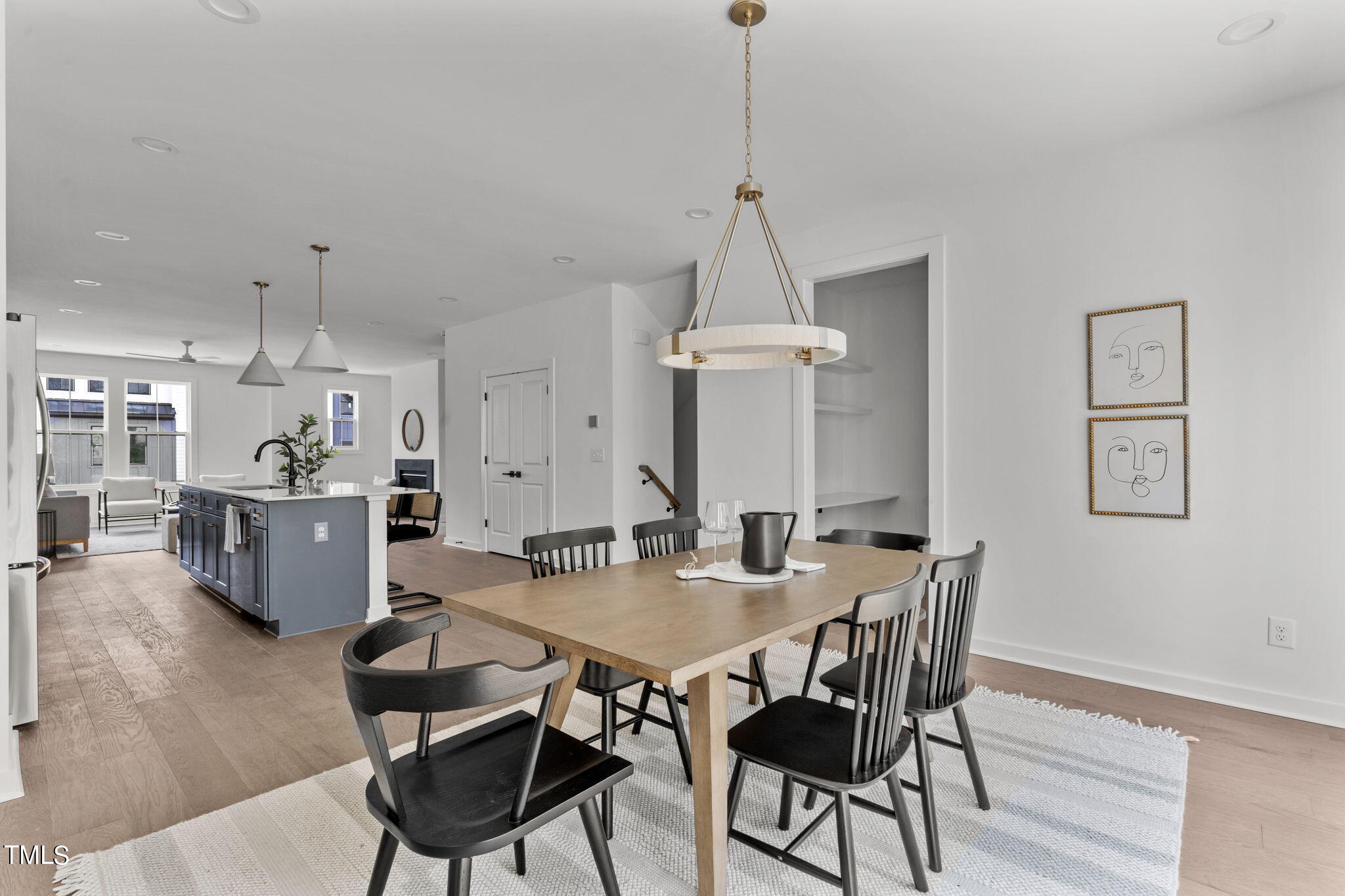 6405 Tanner Oak Lane Raleigh, NC 27613 - Photo 11 of 49 a view of a dining room and livingroom with furniture wooden floor a chandelier