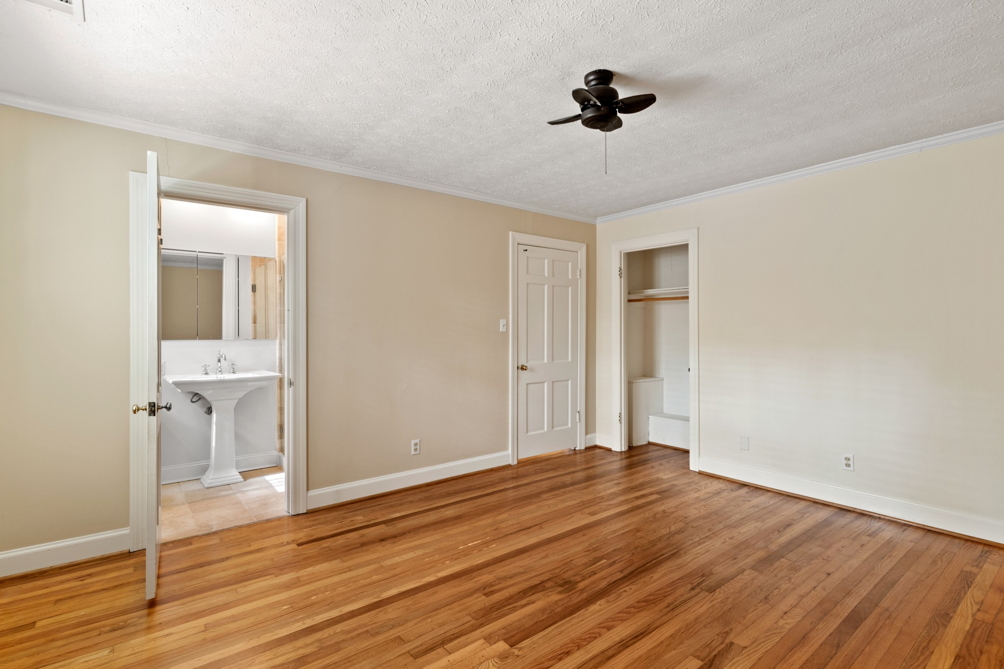 6325 Robin Hill Road Nashville, TN 37205 - Photo 31 of 47 open door leads to other full bath in primary suite. smaller closet on the right. closed door in center on image opens to the hallway