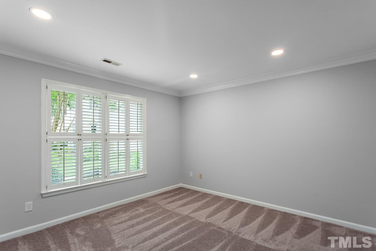 6903 Saxby Court Raleigh, NC 27613 - Photo 6 of 11 The 1st floor bedroom features fresh paint, new carpet and plantation shutters.
