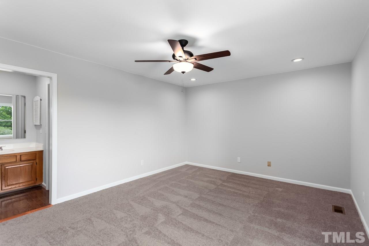 6903 Saxby Court Raleigh, NC 27613 - Photo 7 of 11 The spacious master bedroom is fresh, bright and inviting with its recent facelift and new ceiling fan!