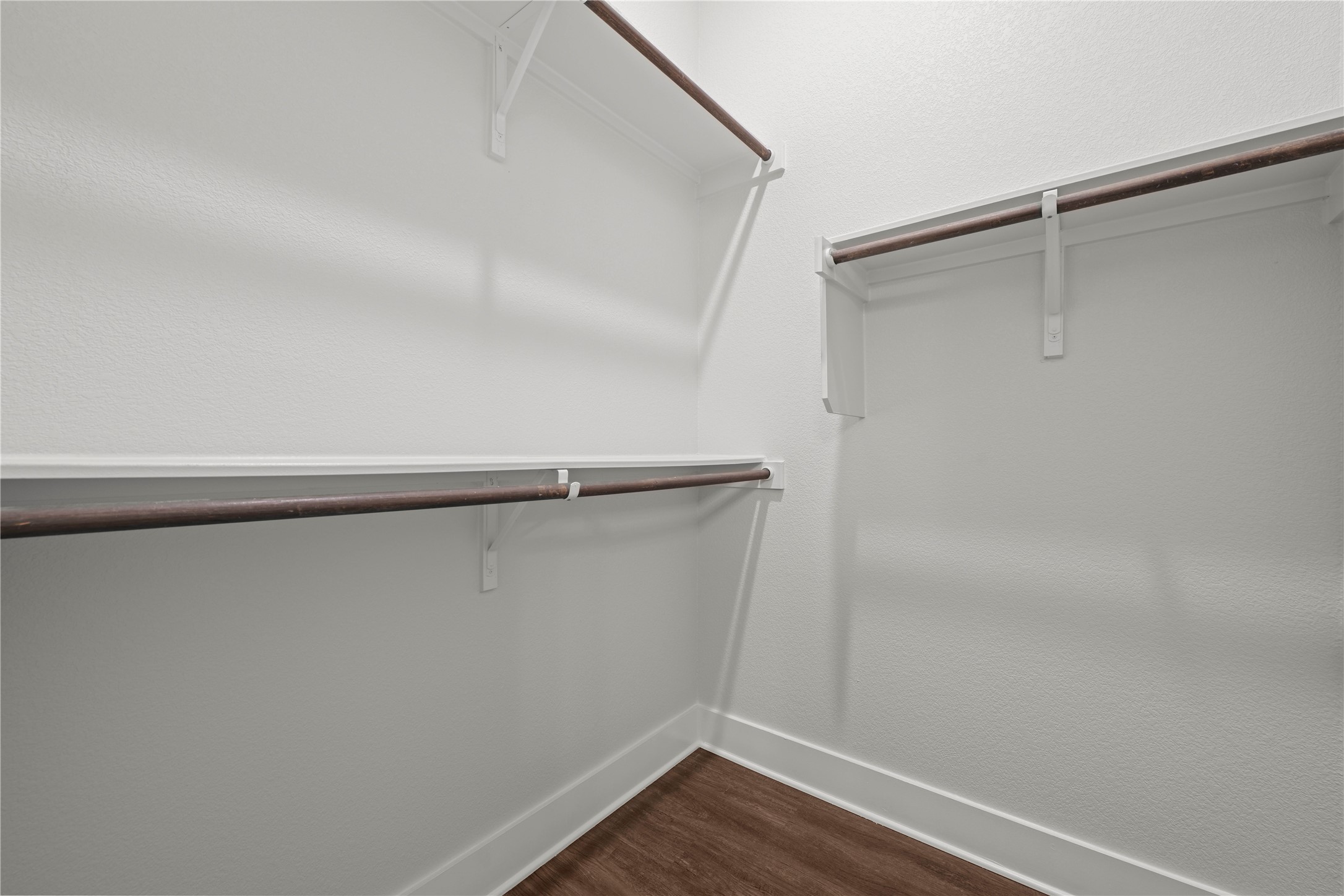 60 Rancho Trail Georgetown, TX 78628 - Photo 23 of 36 Double-hanging rods and built-in shelving maximize storage capacity over clean plank flooring.