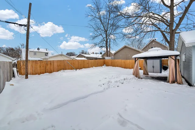 a view of a house with a snow in the yard