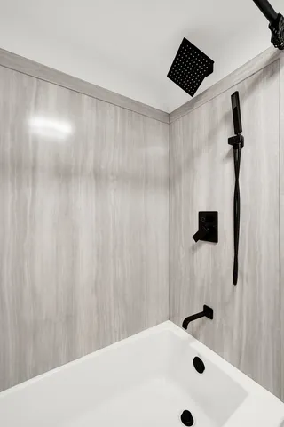 a bathroom with a shower and a shower