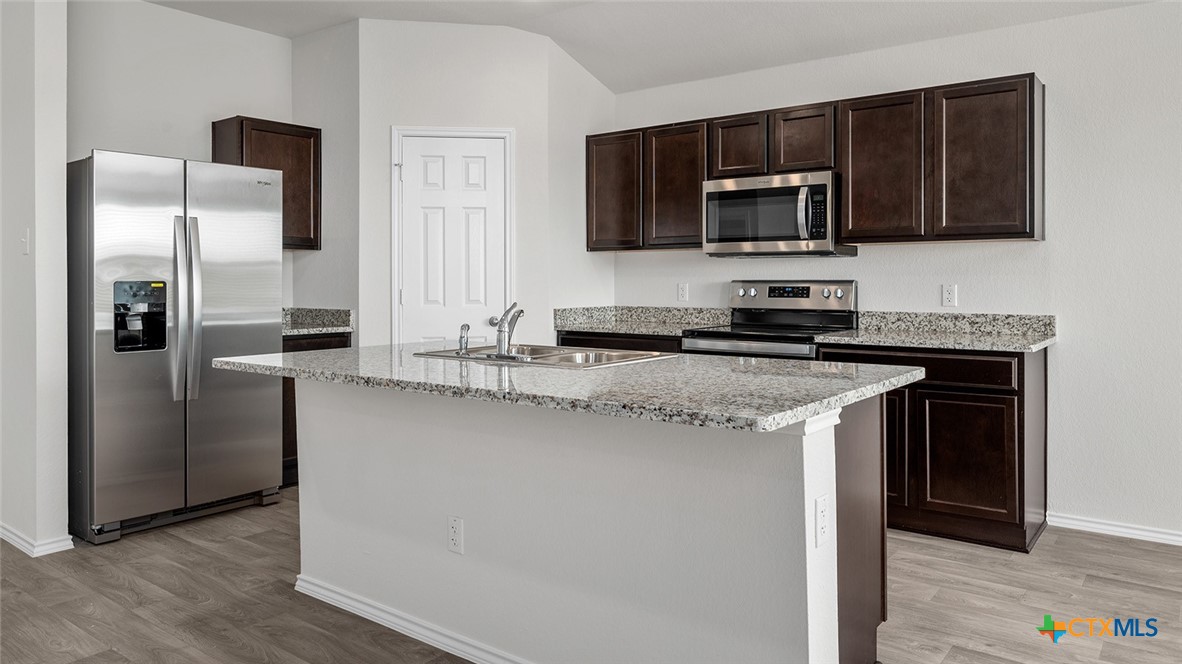 2212 Saffron Road Temple, TX 76501 - Photo 7 of 22 a kitchen with stainless steel appliances granite countertop a refrigerator stove and microwave
