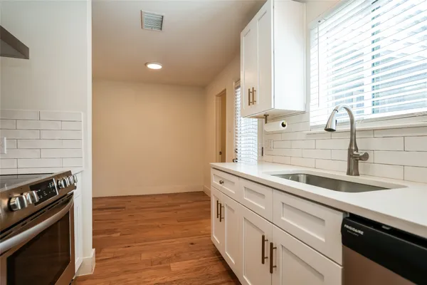 a kitchen with a sink and a stove