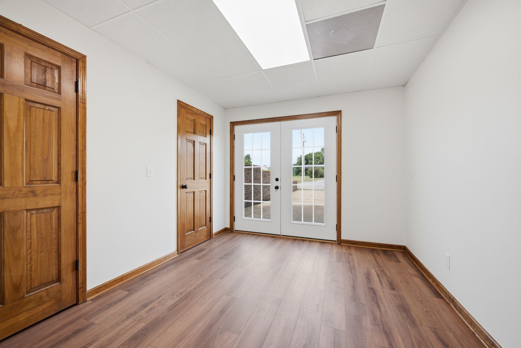 8167 Primm Springs Road Primm Springs, TN 38476 - Photo 44 of 65 an empty room with wooden floor and windows