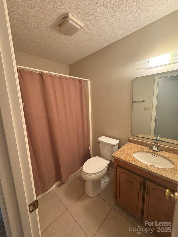 578 Wren Road Gastonia, NC 28056 - Photo 8 of 12 a bathroom with a sink a toilet a mirror and shower