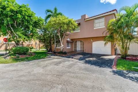 a front view of a house with a yard and a garage