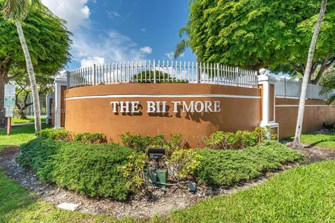a sign broad in front of the red brick house