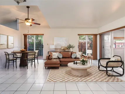 a living room with furniture a window and a table