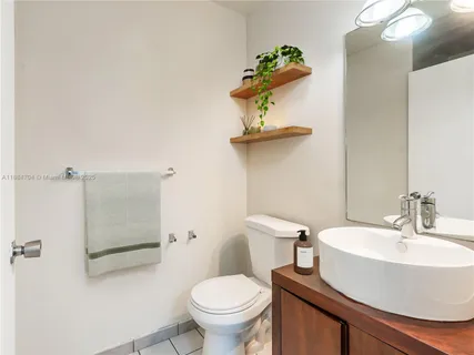 a white toilet sitting next to a bathroom sink