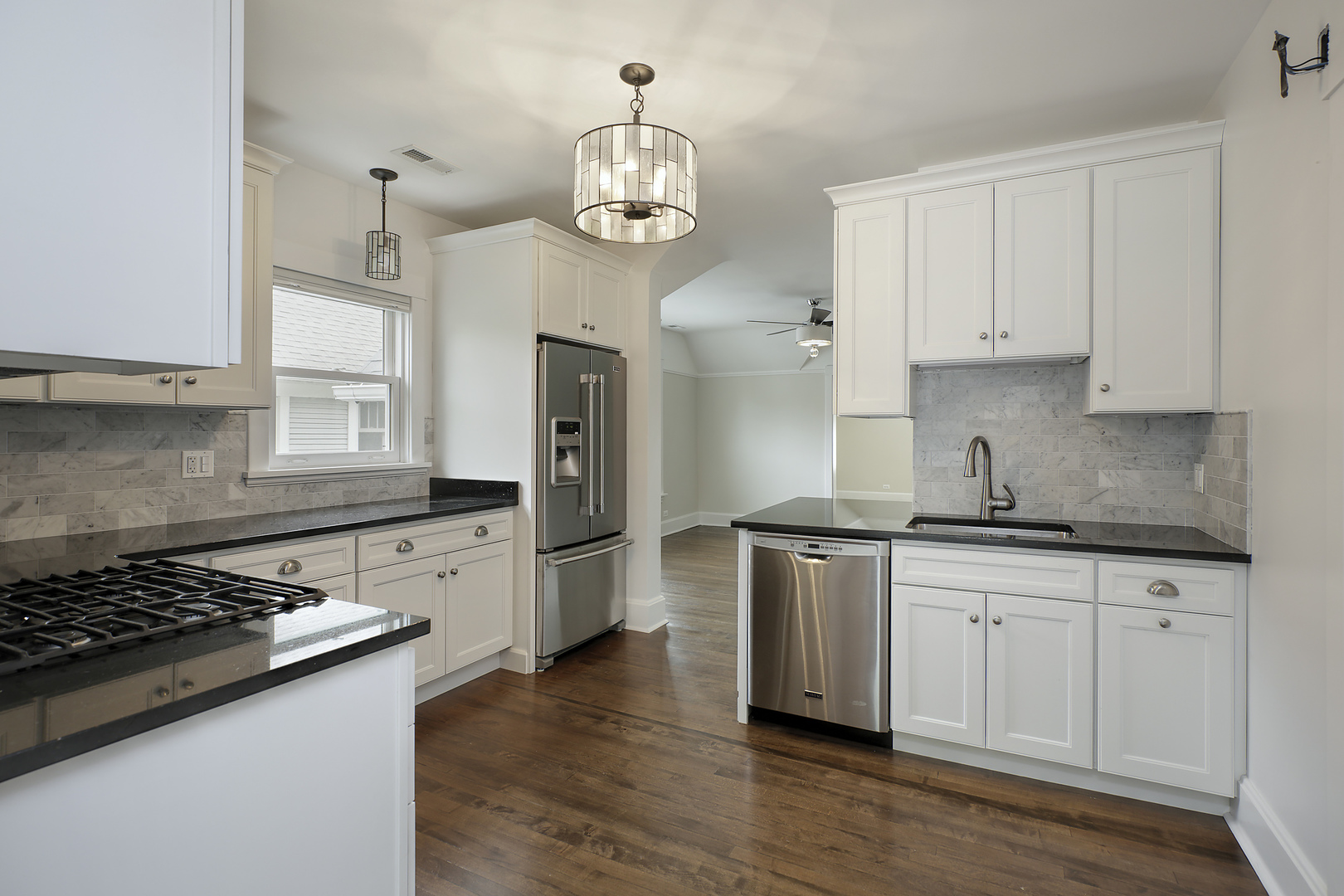 1121 Grant Street, Unit 2 Evanston, IL 60201 - Photo 4 of 8 a kitchen with stainless steel appliances granite countertop a stove and a refrigerator