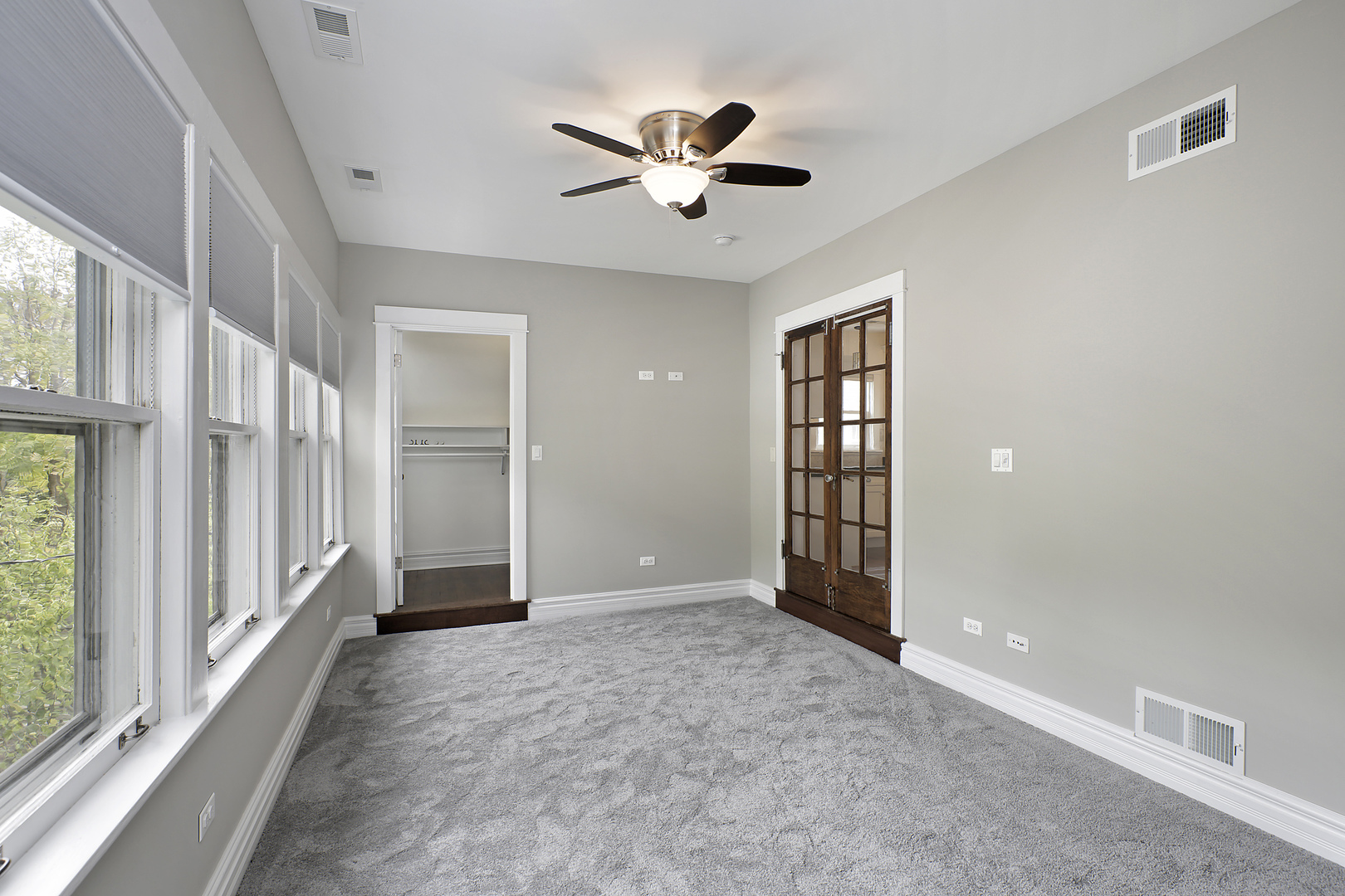 1121 Grant Street, Unit 2 Evanston, IL 60201 - Photo 5 of 8 wooden floor in an empty room with a window