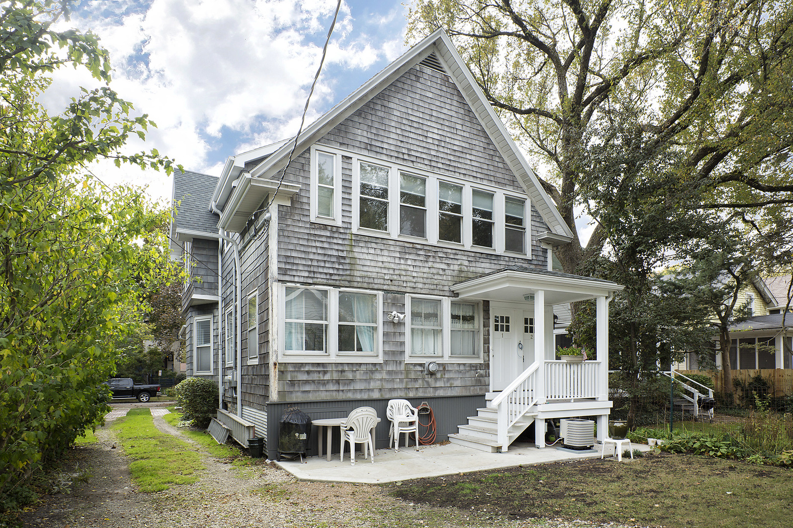 1121 Grant Street, Unit 2 Evanston, IL 60201 - Photo 8 of 8 a front view of a house with yard porch and sitting area