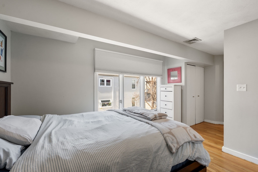 25 Perry Street, Unit 25 Somerville, MA 02143 - Photo 11 of 29 a bedroom with a large bed and a window