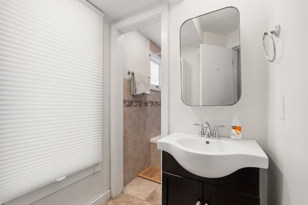 25 Perry Street, Unit 25 Somerville, MA 02143 - Photo 12 of 29 a bathroom with a sink a mirror and shower