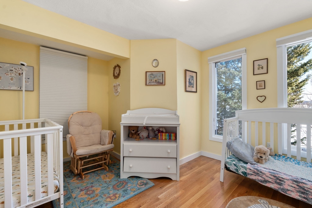 25 Perry Street, Unit 25 Somerville, MA 02143 - Photo 14 of 29 a bedroom with furniture and a wooden floor
