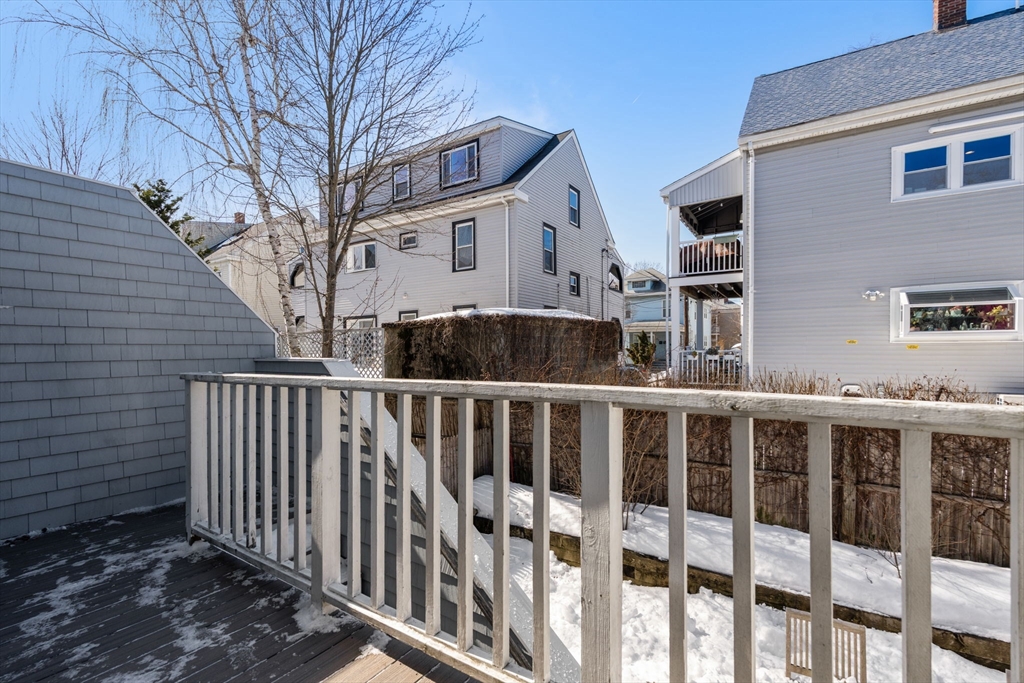 25 Perry Street, Unit 25 Somerville, MA 02143 - Photo 20 of 29 a view of a white house with iron fence