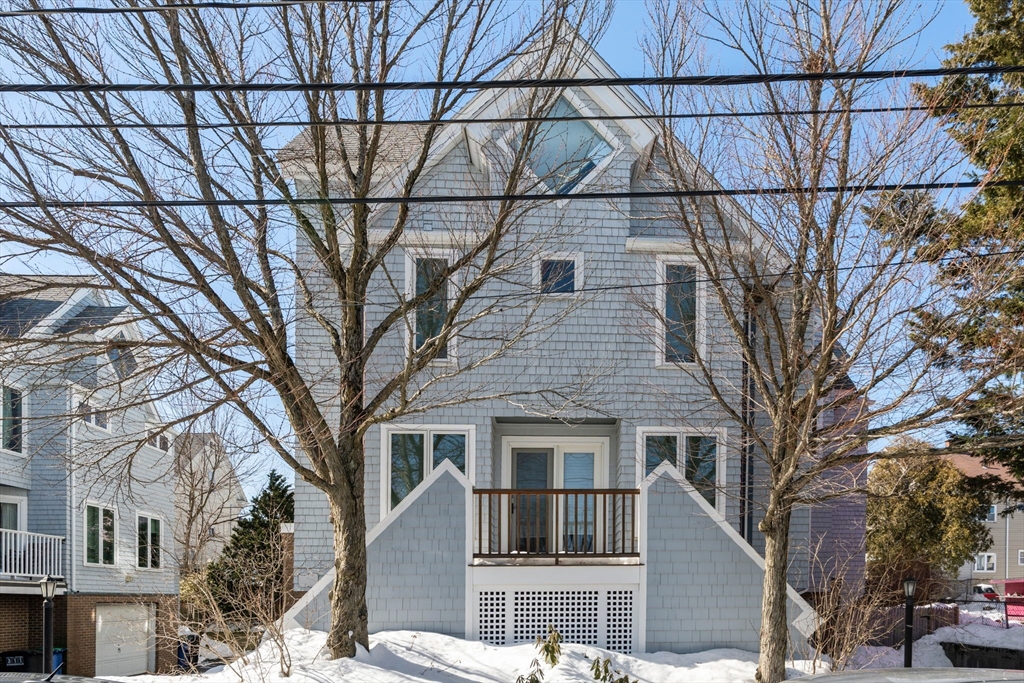 25 Perry Street, Unit 25 Somerville, MA 02143 - Photo 26 of 29 a front view of a house with a yard