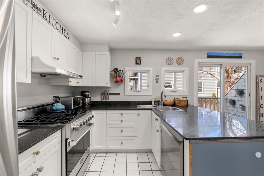 25 Perry Street, Unit 25 Somerville, MA 02143 - Photo 3 of 29 a kitchen with stainless steel appliances granite countertop a sink stove and cabinets