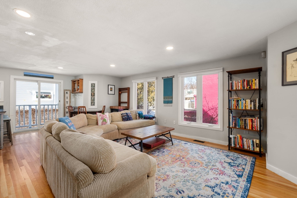 25 Perry Street, Unit 25 Somerville, MA 02143 - Photo 7 of 29 a living room with furniture and a book shelf