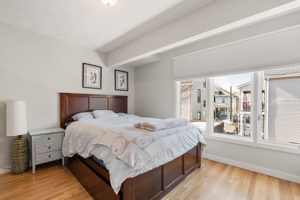 25 Perry Street, Unit 25 Somerville, MA 02143 - Photo 10 of 29 a bedroom with a large bed and a large window