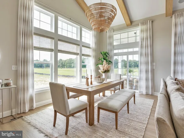 a dining room with furniture a chandelier and wooden floor