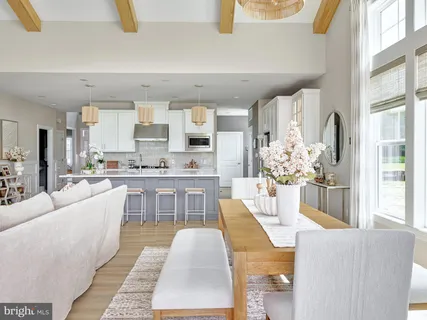 a living room with kitchen island furniture and a chandelier