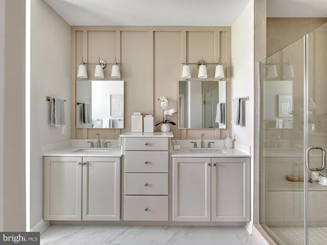 a bathroom with a double vanity sink mirror and double