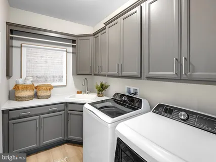 a kitchen with a sink cabinets and appliances