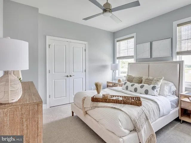 a bedroom with a bed and a lamp