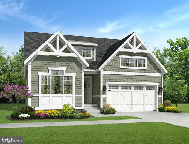 a front view of a house with a yard and potted plants